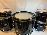 Front view of bass drum, two rack toms and floor tom in dark blue/black finish