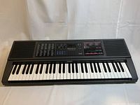 Full view of Casio CTK-550 keyboard showing 61 keys, control panel with tone and rhythm options, digital display, and built-in speakers.