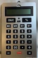Front view of the oversized Staples calculator showing the 12-digit LCD display and oversized keys including numeric, basic operators, percentage, and memory functions.