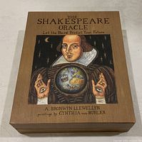 Wooden box with an illustration of William Shakespeare holding a globe and text 'The Shakespeare Oracle, Let the Bard Predict Your Future.' Shows creators A. Bronwyn Llewellyn and Cynthia von Buhler.