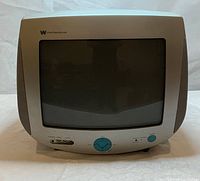Front view of White Westinghouse CRT TV showing screen, manual tuning dials, speaker, and power button.