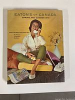 Front cover of the Eaton's of Canada Spring and Summer 1961 catalogue featuring a woman on the phone.