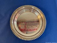 Top view of the round silver dish showing polished surface and twisted rope edge design.