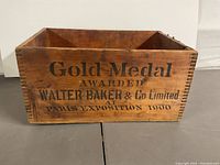 Left side of wooden box showing text 'Gold Medal Awarded Walter Baker & Co. Limited At Paris Exposition 1900'