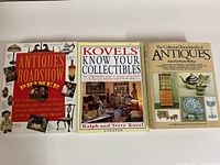 Photo showing all three antique reference books stacked side by side.