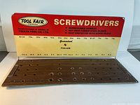 Front view of the vintage Fuller Tool Co. Ltd metal store display rack with pricing and screwdriver type details visible.