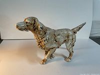 Photo of vintage Hubley dog door stop in standing pose, viewed from the side showing detailed fur texture and raised tail