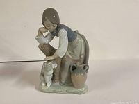 Front view of Lladro porcelain statue of girl with dog, showing detailed faces and pose.