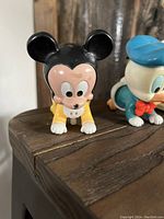 Close-up photo of the vintage Mickey Mouse wind-up figure showing face and ears.