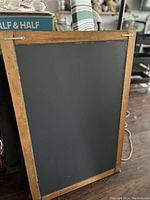 Rear view of the framed panel mirror showing wooden backing and hanging hardware.