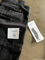Black pants with tag labeled 'up!', size 16.