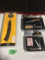 Photo of the Buck fixed special edition gift set and Browning pocket knives in original packaging showing two sets of knives and their display arrangement.