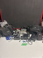 Overview of eight cameras with two cases on table