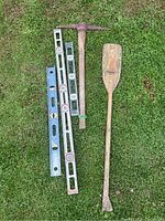 Full view of all items laid on grass showing three levels, pickaxe, and wooden oar.