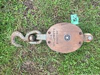 Top view of the vintage pulley showing wood block with metal hook and company marking ‘Boston & Lockport Block Co’