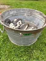 Photo of vintage metal wash basin with signs of rust and wear, showing interior and exterior surfaces