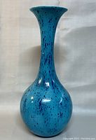 Full front view of the blue art glass vase showing color and shape.