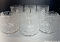 Eight textured glass tumblers in two rows showing icicle pattern and droplet feet
