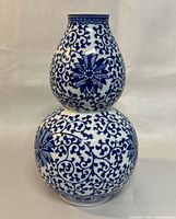 Front view of the double gourd vase showing the overall shape and blue floral decoration.