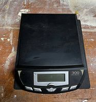 Top view of the black digital scale measuring device with an LCD display turned off.