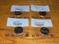 All four uncirculated coins sealed in plastic with state and year labels shown from the front.