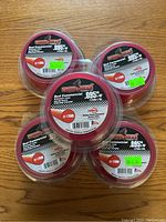 Five rolls of red commercial .095" diameter grass/weed trimmer line brand Foresight, packaged in clear plastic containers with labels.