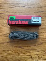 Kershaw branded box with closed folding knife showing textured handle and pocket clip.