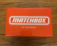 Top view of sealed orange Matchbox box with white and orange logo and product name.