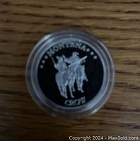 Top view of the coin showing mounted figures and 'MONTANA CROW' inscription