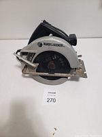 Photo of Black & Decker circular saw showing side view with blade and markings visible.