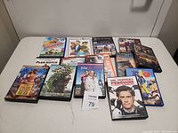 Top view photo showing twelve different kids and family DVD cases arranged in two rows on a white surface.