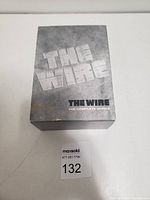 Front of The Wire DVD complete series box set showing embossed silver-grey cover with title text.