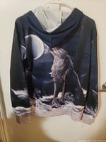 Back view of wolf howling hoodie sweater with full moon and night sky design