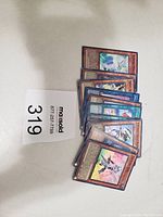 Stack of 10 Yu-Gi-Oh holographic cards with visible character artwork and text, confirming condition as excellent and holographic nature of the cards.