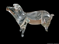 Crystal pig figurine viewed from one side showing clear transparency and detailed features including legs, tail, and snout.
