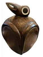 Front view of vintage wooden bird carving showing stylized wing shapes, large round eyes, and smooth wood grain texture.