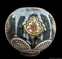 Front view showing floral hand painted decoration and dripped glaze