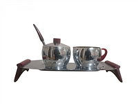 Front view of the chrome creamer and sugar set on tray with Bakelite handles and spoon.