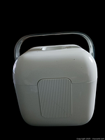 Side view of white plastic ice bucket showing ribbed rectangular detail and metal handle.