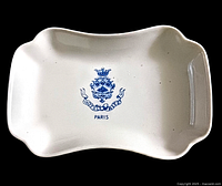 Top view of the white porcelain ashtray/trinket dish showing the blue Hotel Ritz Paris emblem and lettering.