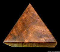 Top view of triangular vintage wooden trinket box showing birds eye maple wood grain and finish.