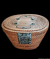 Top view of the vintage hand woven wicker tea basket tote showing intricate woven pattern, brass handle, and latch on the lid.