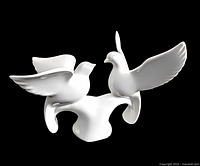 White fine bone china figurine of two flying doves on a base, viewed from one side.