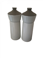 Front and side view of two ceramic salt and pepper shakers with brown tops and white bodies