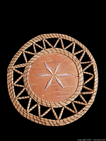 Top view of the vintage Indigenous Canadian birch bark trivet showing porcupine quill decoration on the front center and woven edge details.