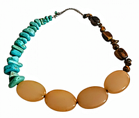 Front view of vintage multi gemstone necklace showing turquoise stone chips, oval moonstone beads, and tiger eye stone beads arranged in a single strand with a chain and clasp.