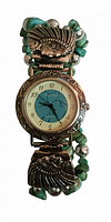 Front view of the watch showing turquoise center dial, silver-tone etched case, and beaded band with turquoise stone chips and silver beads.