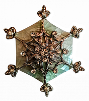 Front view of vintage pentagon-shaped enamel brooch with rhinestone starburst design.