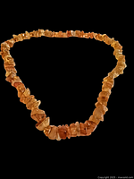 Single strand amber necklace laid flat to show full length and bead shape.