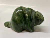 Side view of polished green marble beaver carving showing the detailed shaping and natural veining.